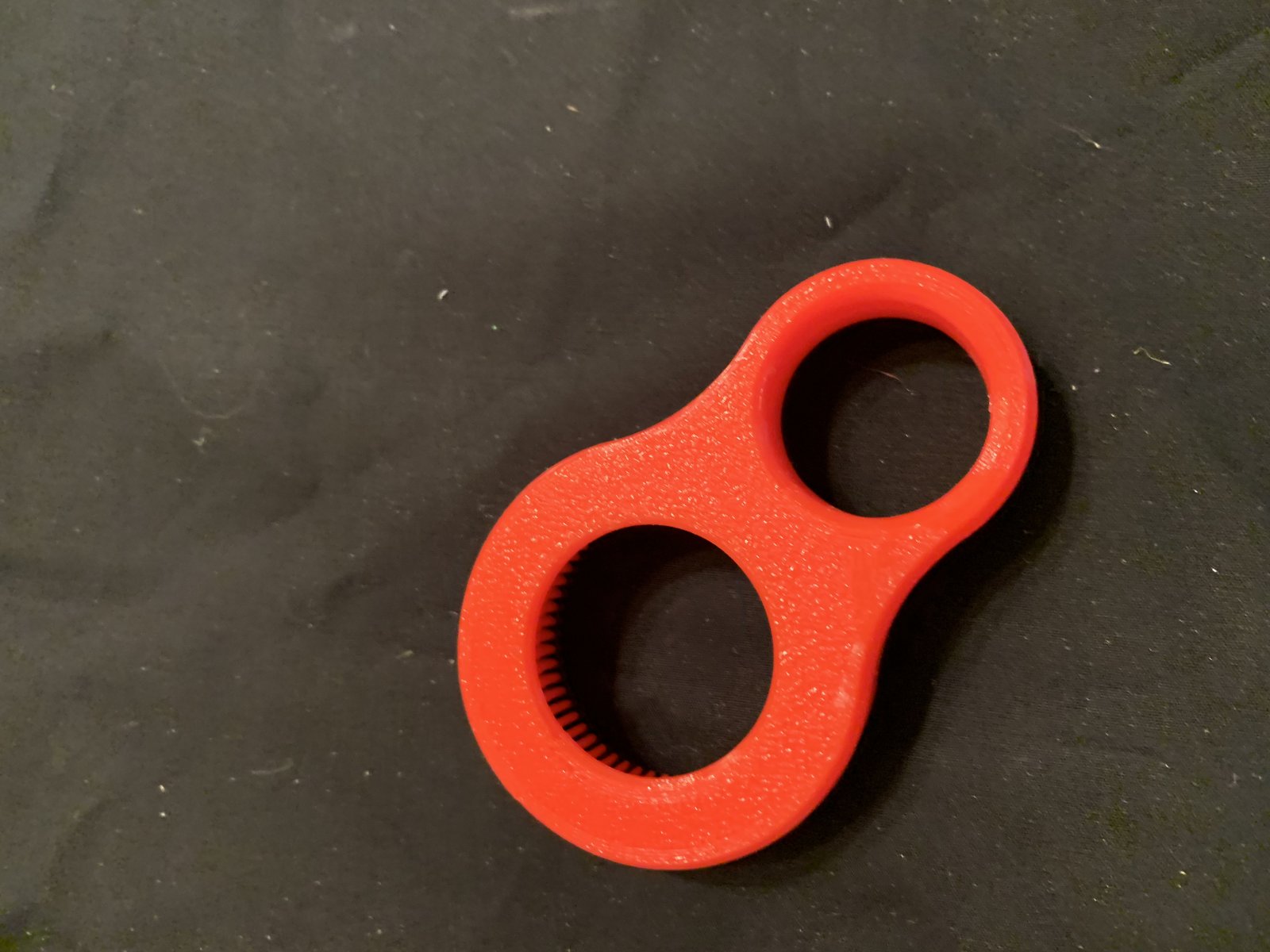 3D printed figure-eight shaped bottle opener designed for arthritic hands