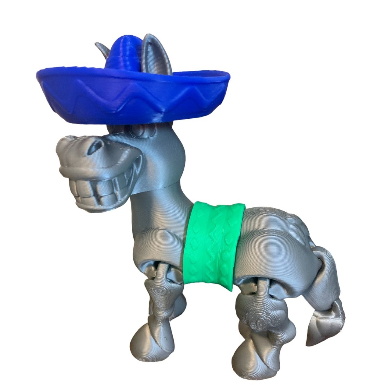3D printed articulated donkey wearing a blue sombrero and green saddle